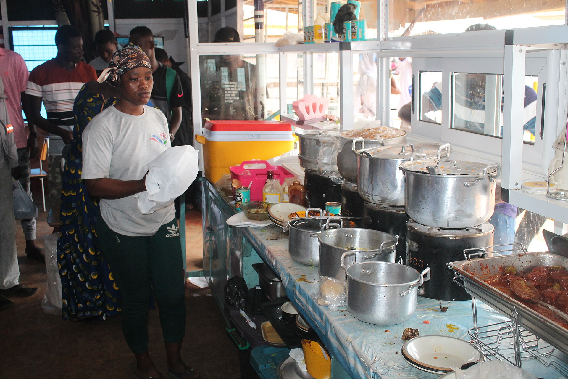 A chop bar owner serving food in Ghana
